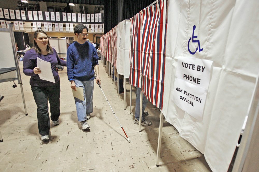 The voting rights of America's disabled citizens must be dealt with now, writes Ross Doerr. Pictured: A blind man is helped to a voting booth by an election worker in Montpelier, Vt. (Toby Talbot/AP)
