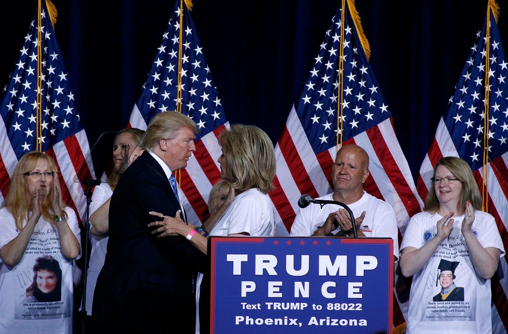 Republican presidential candidate Donald Trump shares the stage with people whose family members were killed by undocumented immigrants during a campaign rally outlining his Immigration Policy on Aug. 31, 2016 in Phoenix, Arizona. (Ralph Freso/Getty Images)