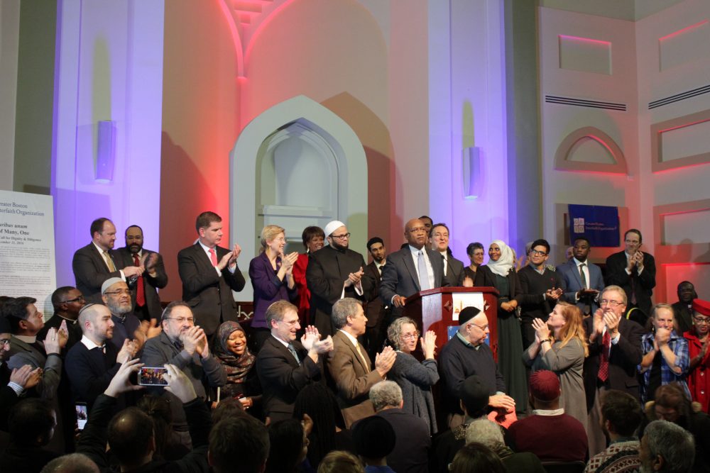 Rev. Dr. Ray Hammond of Bethel AME, joined by faith leaders and elected officials, closed out the interfaith event Sunday night. (Shannon Dooling/WBUR)