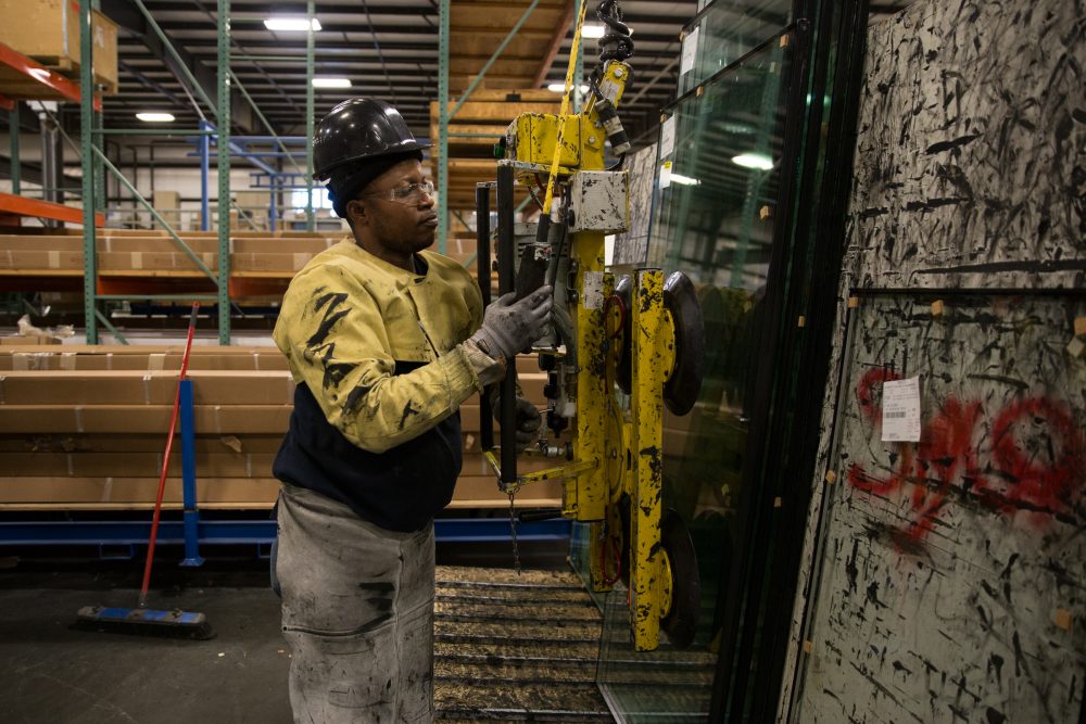 About a third of workers at SIGCO, in Westbrook, Maine, are immigrants. Worker Antonio Pedro came to the United States from Angola three years ago. (Ryan Caron King/NENC)