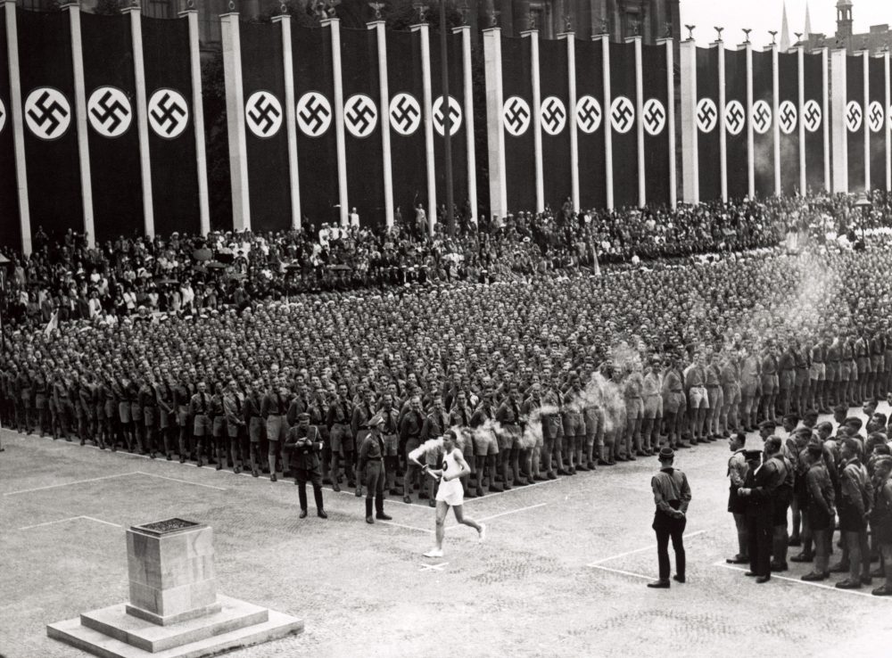 The 1936 Olympics were held in Berlin. That gave sportscaster Ted Husing a good cover to help save his relatives in Germany. (Getty Images)