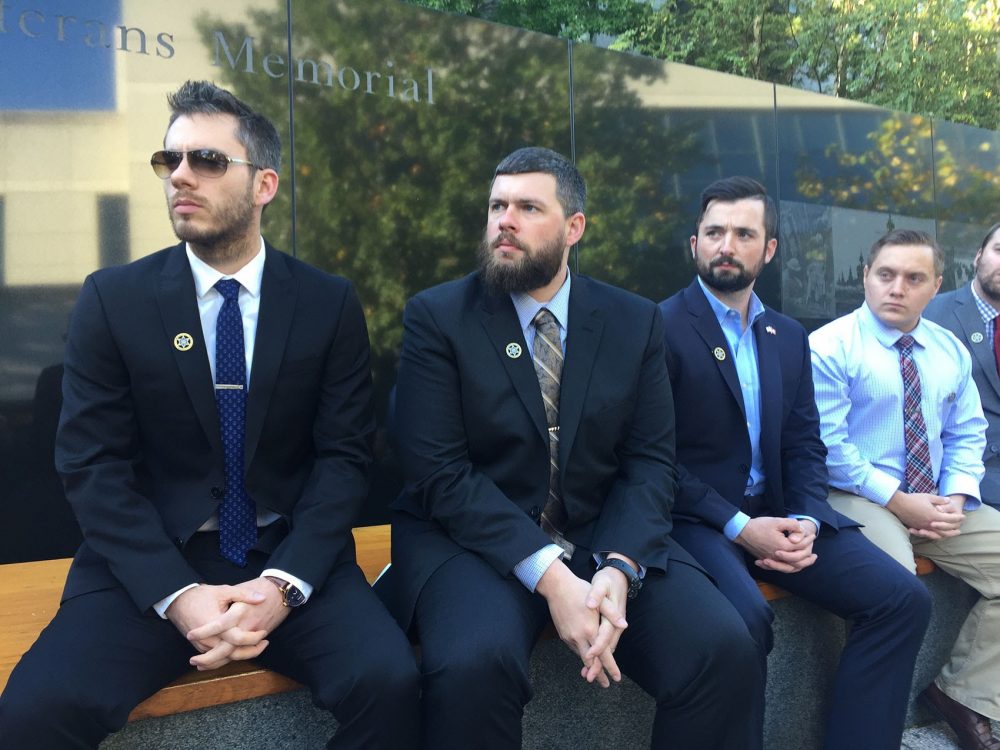 Veterans, including John McGuinness (second from left), attend a ceremony marking the institution of Robert R. Pirelli VFW Post 12158 at Northeastern University. (Fred Thys/WBUR)