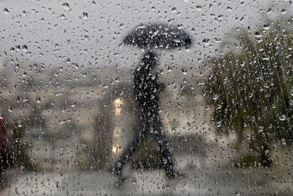 Raindrops appear on a window as a man crosses a street in San Francisco, Wednesday, Jan. 4, 2017. (Jeff Chiu/AP)