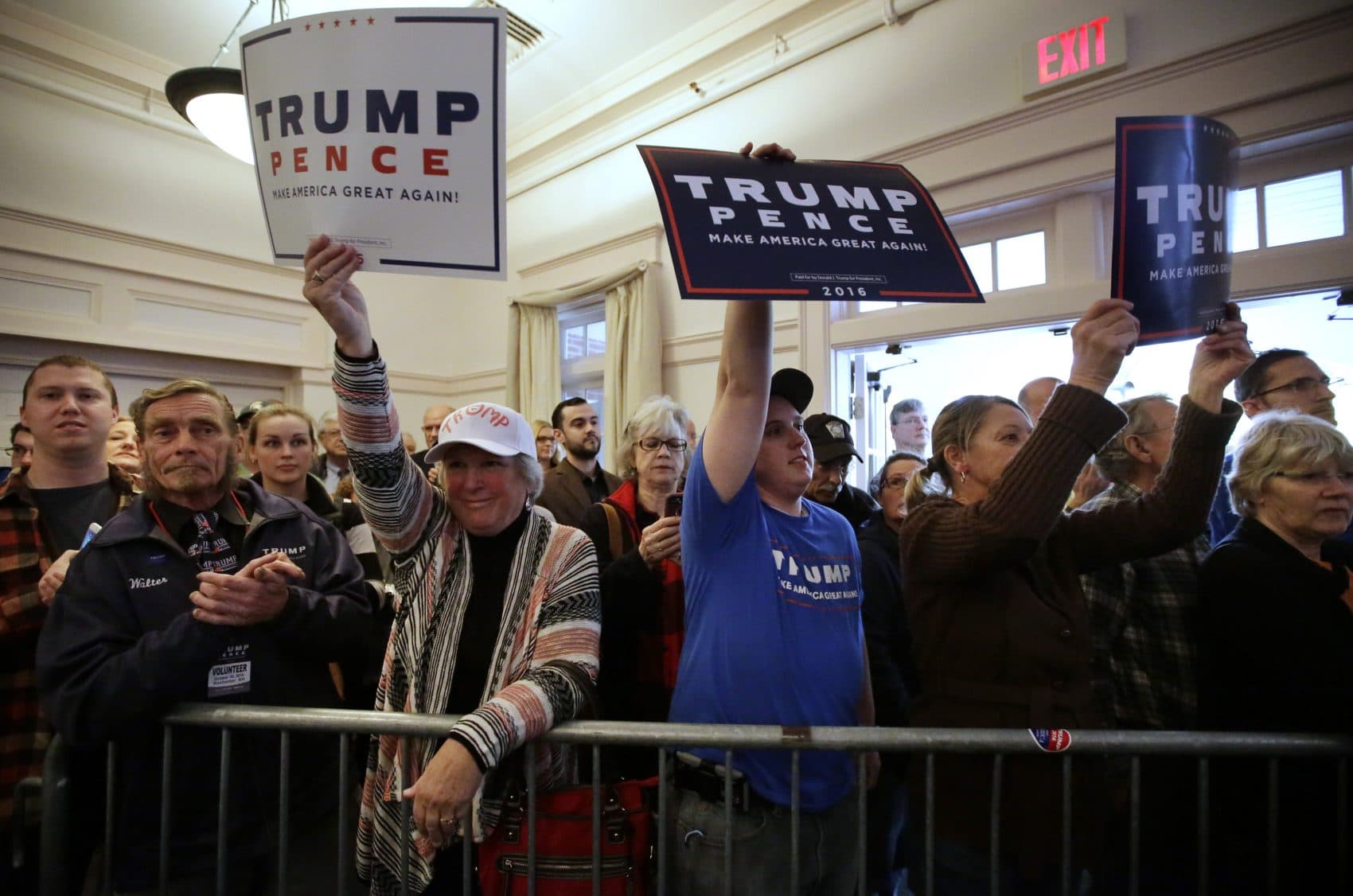 Supporters of Donald Trump and Mike Pence display placards during a campaign stop in Rochester, N.H. during the 2016 campaign. (Steven Senne/AP)