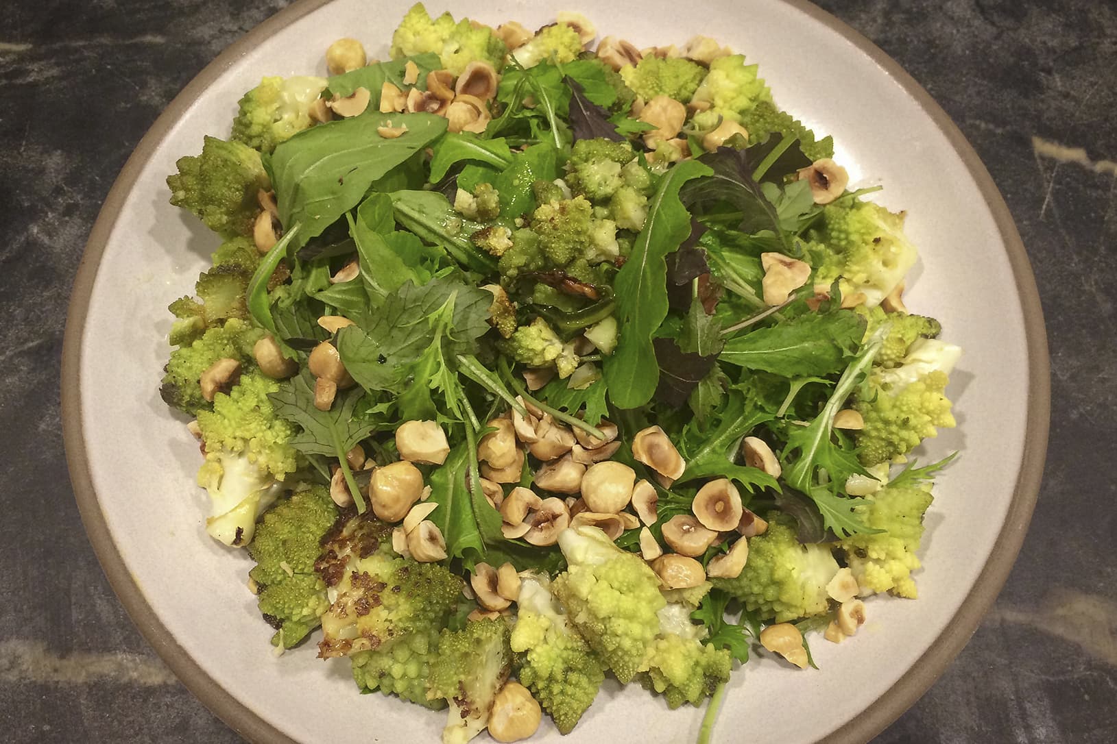 Kathy's roasted cauliflower salad with winter greens, toasted hazelnuts and tahini vinaigrette. (Kathy Gunst for Here & Now)