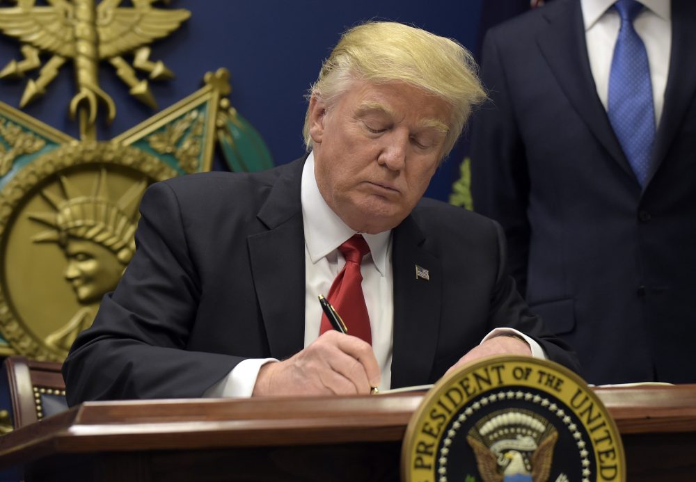 President Donald Trump signs an executive order on "extreme vetting" during an event at the Pentagon Friday. (Susan Walsh/AP)