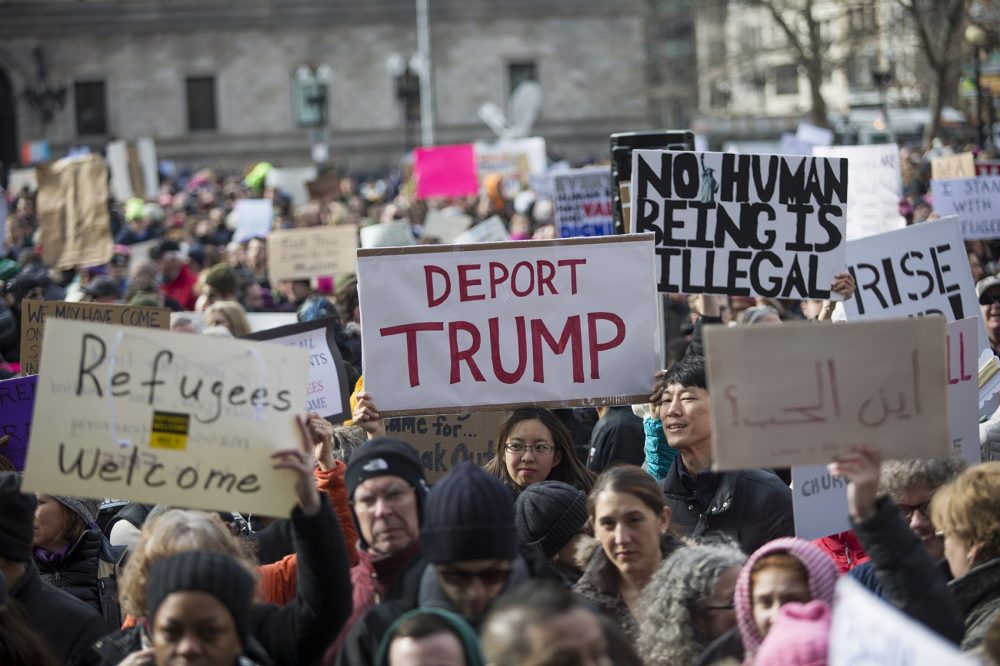 Copley Square was awash with signs protesting the executive order Sunday afternoon. (Jesse Costa/WBUR)