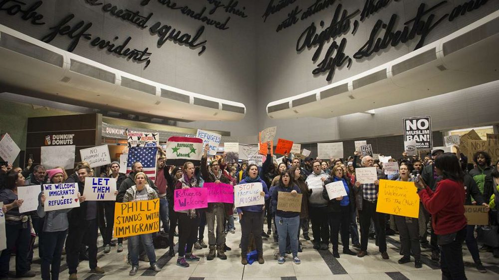 Protesters angered by President Donald Trump’s executive order that prevented refugees, visa and green card holders from entering the US chant pro-immigration slogans at Philadelphia International Airport. (Branden Eastwood for NewsWorks)