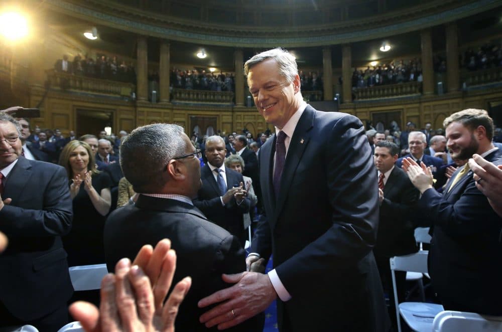 Massachusetts Republican Gov. Charlie Baker, center, greets law makers and guests as he enters the House chamber at the Statehouse before his State of the State address, Tuesday, Jan. 24, 2017, in Boston. (AP Photo/Steven Senne)