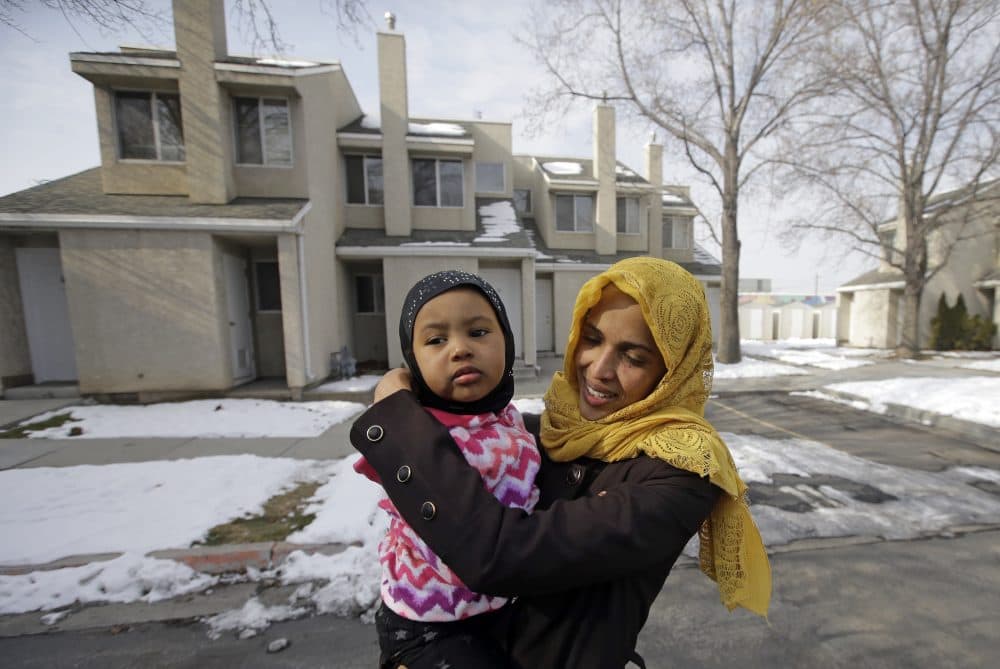 Somali refugee Nimo Hashi hugs her daughter Taslim at their home Tuesday, Jan. 31, 2017, in Salt Lake City. Hashi bought a new kitchen table and couches for her Salt Lake City apartment in joyful anticipation of reuniting Friday with her husband for the first time in nearly three years. But he won't be arriving as planned to see her and the 2-year-old daughter he's never met. He is among hundreds of people stuck in limbo after President Donald Trump's executive order temporarily banned refugees and nearly all travelers from seven Muslim-majority countries, including Somalia. (Rick Bowmer/AP)