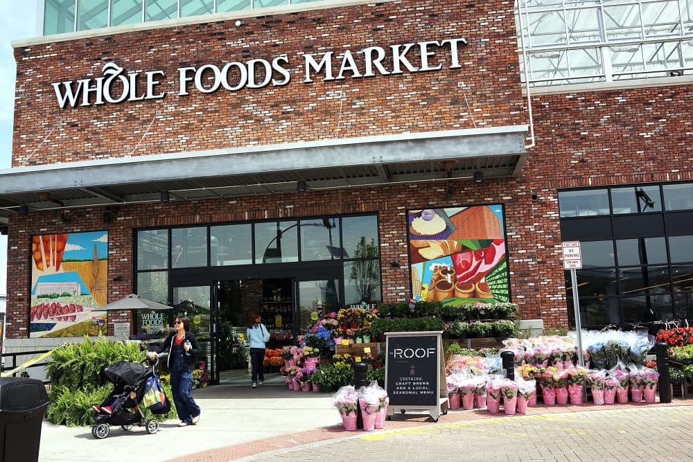 People walk out of a Whole Foods Market in the Brooklyn borough of New York. (Spencer Platt/Getty Images)