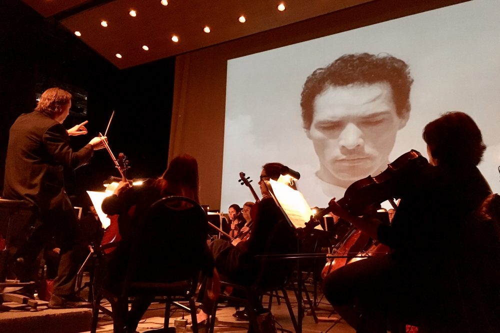 A screening of the iconic Mexican film "Redes" at the Music Unwound festival, accompanied by the El Paso Symphony Orchestra, which performed the score live. (Armando Trull/WAMU)
