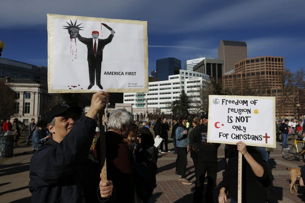 Calling Trump "chaotic" and "a pathological liar," influential publications around the world are advising their country's leaders to oppose him. Pictured: A man holds a sign depicting the cover of the German magazine Der Spiegel during a rally to protest President Donald Trump's executive order to temporarily ban some refugees from seven mostly Muslim countries, in Denver, Saturday, Feb. 4, 2017. (Brennan Linsley/AP)