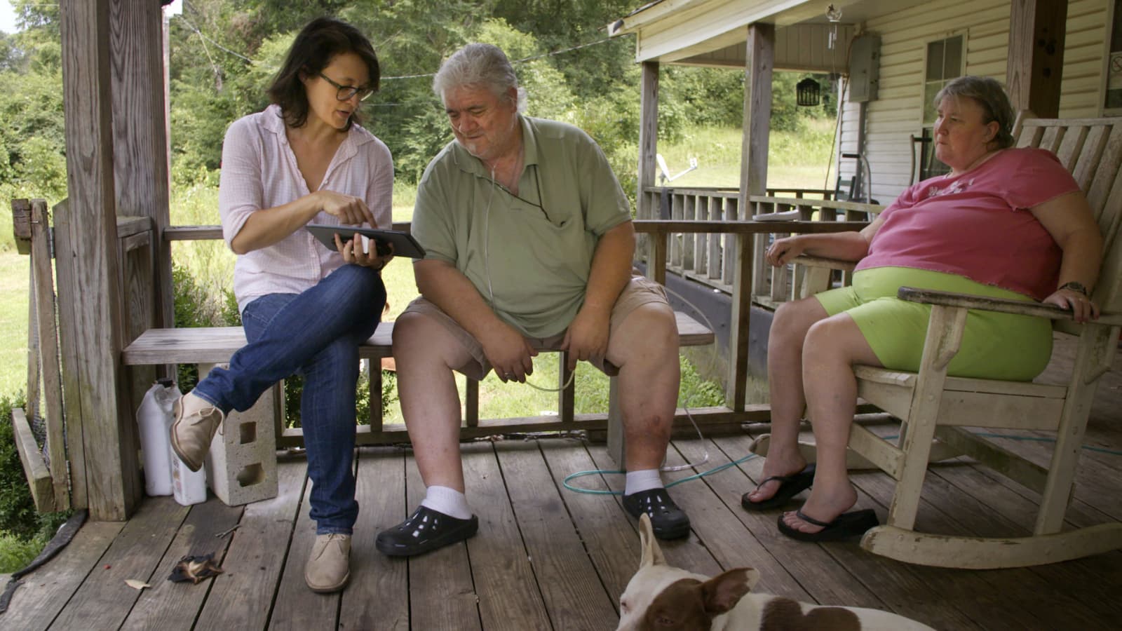 Filmmaker Jennifer Crandall (left) sits with Billy Wayne Corkerin and his wife Lucy Corkerin on the porch of their home in Fayette, Ala. The couple read verse 43 of the Walt Whitman poem "Song of Myself" for the project "Whitman, Alabama." (Courtesy Pierre Kattar)