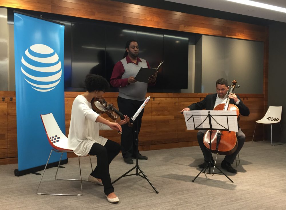 Castle of our Skins members Ashleigh Gordon, Fred VanNess and Javier Caballero perform at the AT&T space in Boston. (Amelia Mason/WBUR)