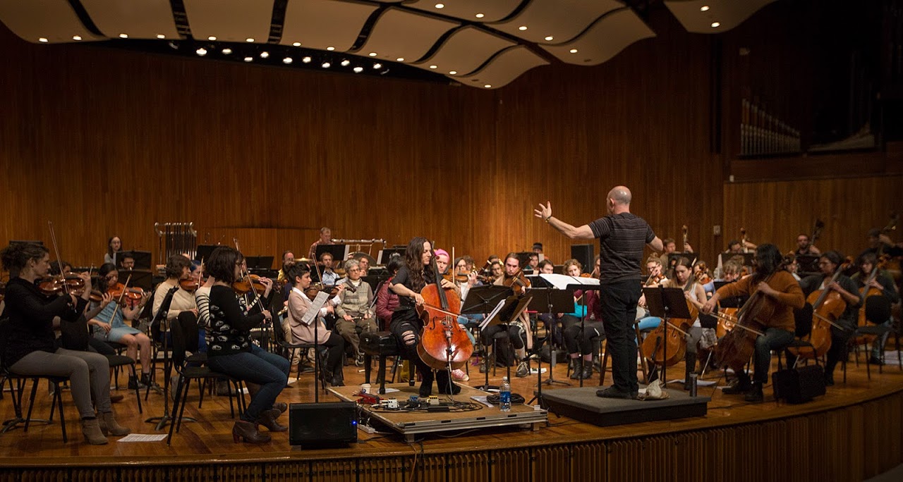 MIT professor Evan Ziporyn conducts a rehearsal of his arrangement of David Bowie's "Blackstar" featuring cellist Maya Beiser. (Jesse Costa/WBUR)