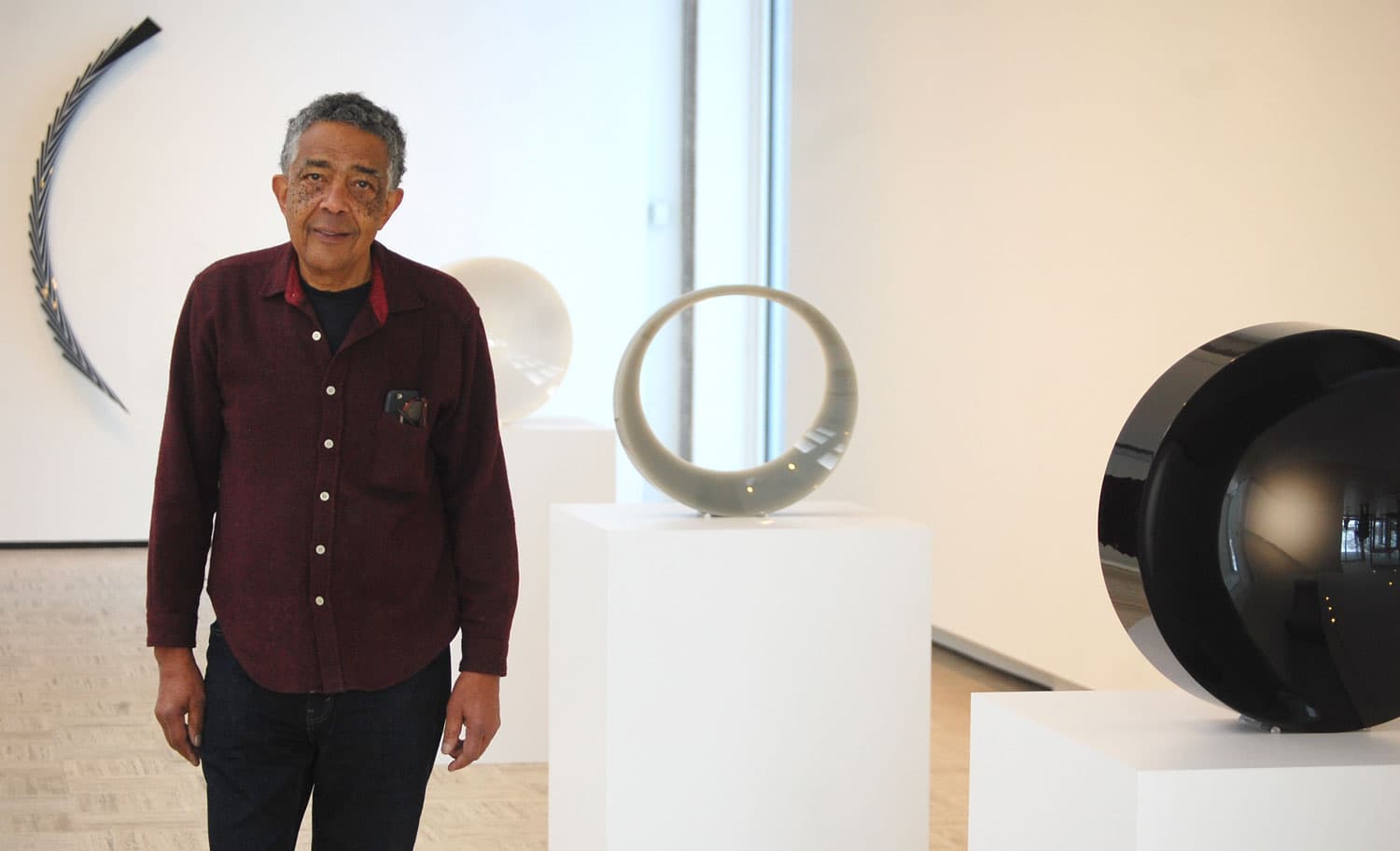 Fred Eversely at his exhibit "Black, White, Gray" at Brandeis University’s Rose Art Museum. (Greg Cook/WBUR)
