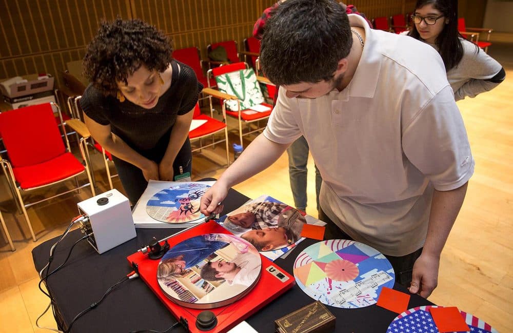 Drama student Craig Cummings places a disk onto a turntable to listen to his recording for the first time. (Robin Lubbock/WBUR)