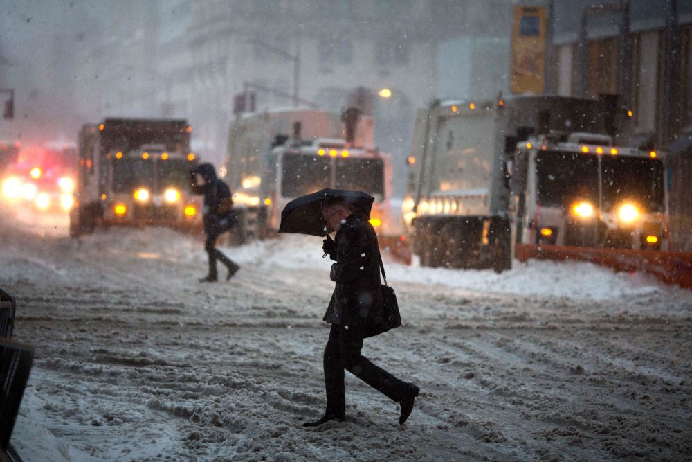 Snow plows line up on Fifth Avenue during a day of heavy snow and freezing rain on March 14, 2017, in New York. (Kevin Hagen/Getty Images)
