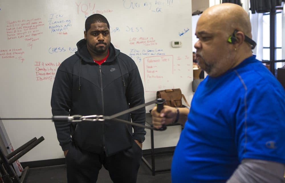 InnerCity Weightlifting trainer Angel LaCourt works with 65-year-old Cambridge resident Bill Gramby, who recently had a stroke and is working out to build strength and stamina. (Jesse Costa/WBUR)