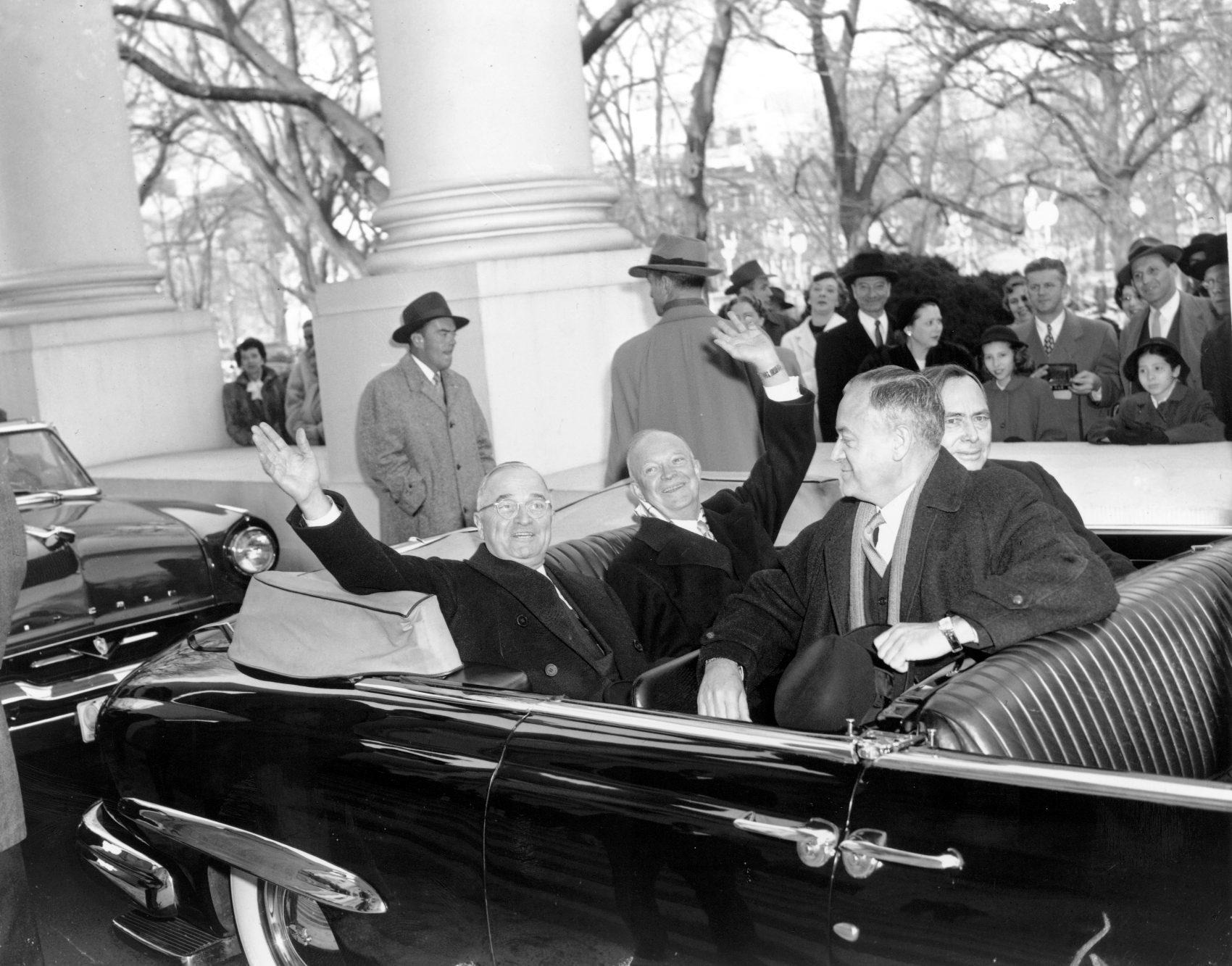 With smiles and a wave, President Harry Truman, left, and his successor, president-elect Dwight D. Eisenhower, leave the White House in an open car for inauguration ceremonies in Washington, D.C. on Jan. 20, 1953. Sitting in the front is Sen. Styles Bridges of New Hampshire, and behind him is House Speaker Joe Martin. (AP)