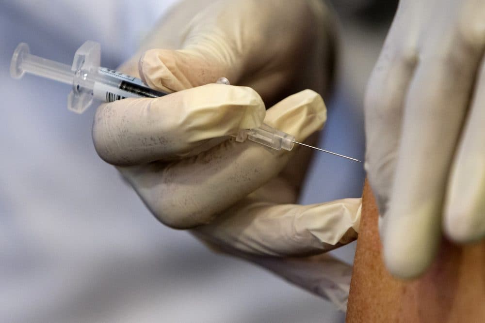 In this Sept. 17, 2015, file photo, a nurse administers a flu vaccine shot in Washington. (Jacquelyn Martin/AP)