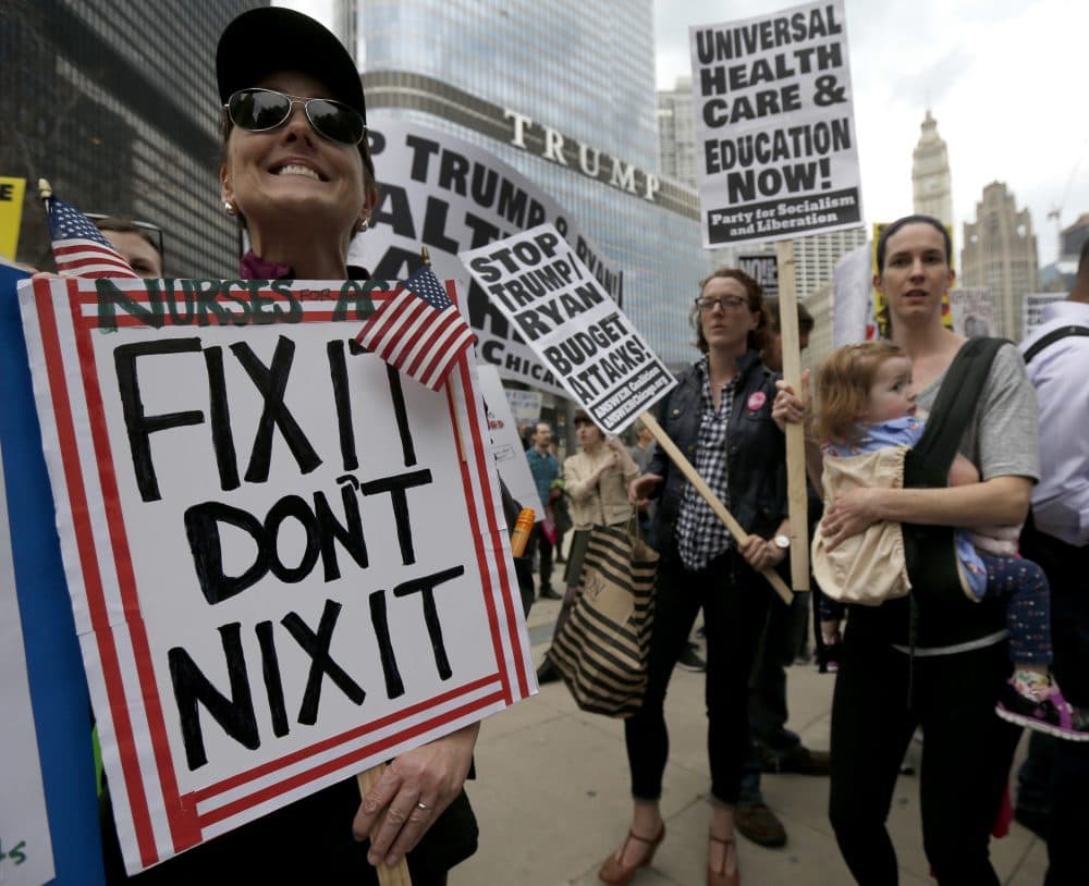 Pictured: Protesters gather across the Chicago River from Trump Tower to rally against the repeal of the Affordable Care Act Friday, March 24, 2017, in Chicago. Earlier, President Donald Trump and GOP leaders yanked their bill to repeal "Obamacare" off the House floor Friday when it became clear it would fail badly. (Charles Rex Arbogast/AP)