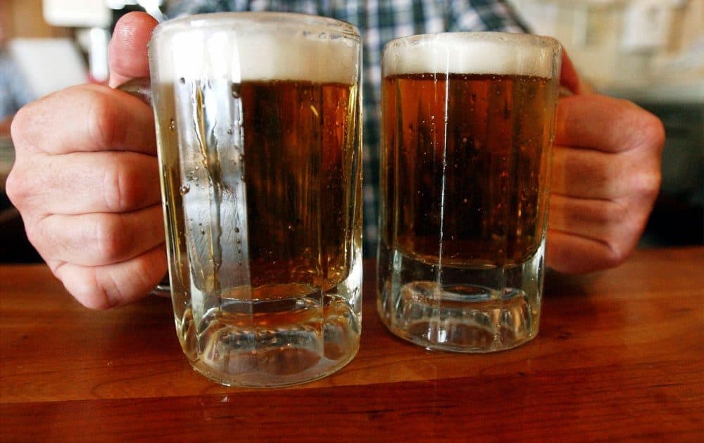 We as a medical community do not take unhealthy alcohol use as seriously as we should, writes Dr. Elisabeth Poorman. The first obstacle we have to face is a fundamental misunderstanding of the problem itself. Pictured here: A bartender serves two mugs of beer at a tavern in Montpelier, Vermont. (Toby Talbot/AP)