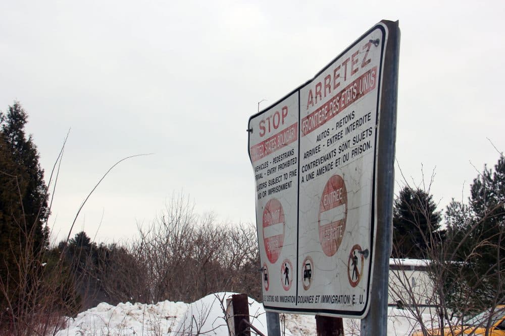 This sign marks the Canadian side of the border at one rural area where many people are crossing illegally from New York into Canada. Mamadou was in the woods somewhere within 20 miles of here. (Kathleen Masterson/VPR)