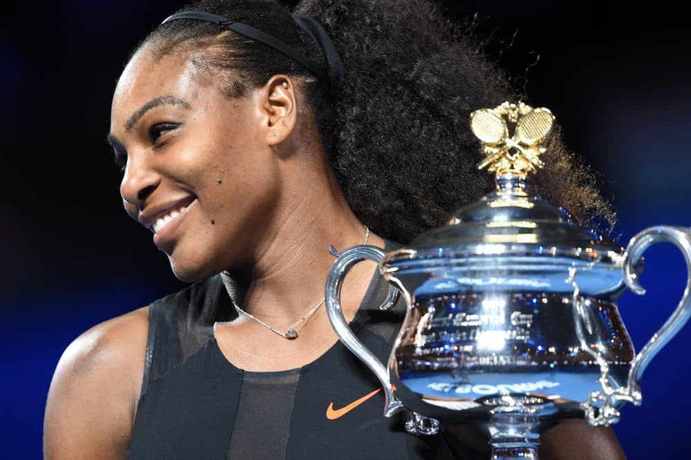 Serena Williams holds up the trophy following her victory over her sister Venus Williams in the women's singles final of the Australian Open tennis tournament in Melbourne on Jan. 28, 2017. (Paul Crock/AFP/Getty Images)