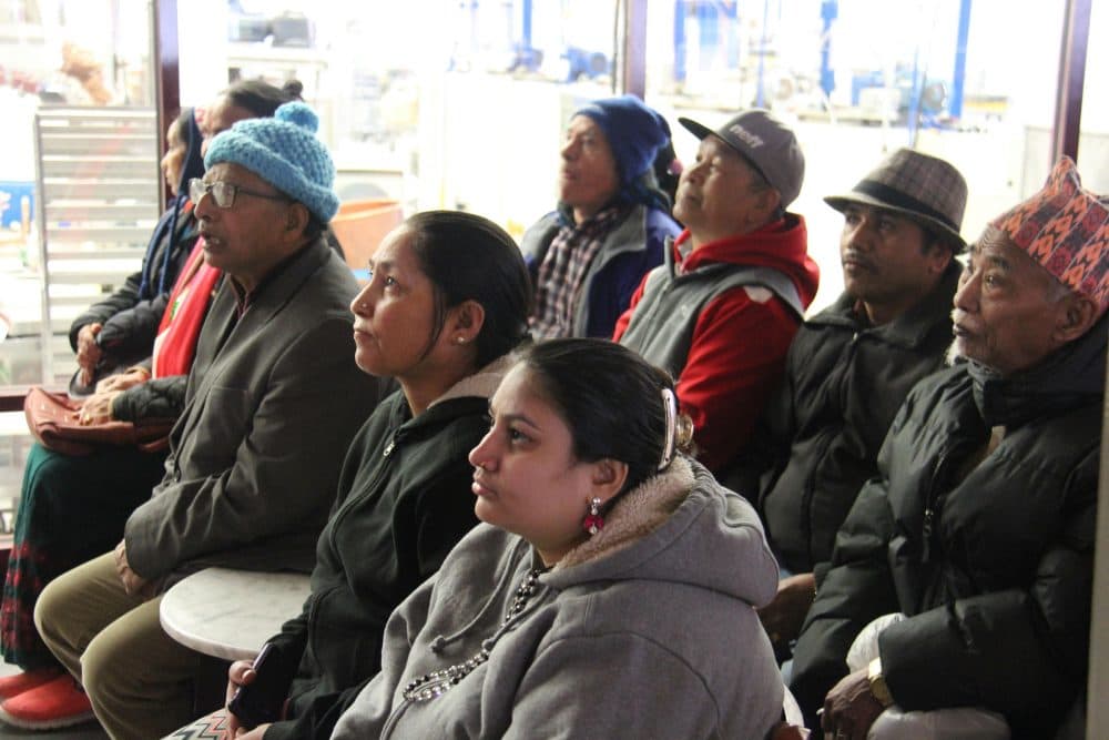Ajuda Thapa, center in black, learns about Lake Champlain Chocolates on an outing with other Bhutanese refugees who have sought mental health treatment at UVM's Connecting Cultures clinic. (Kathleen Masterson/VPR)
