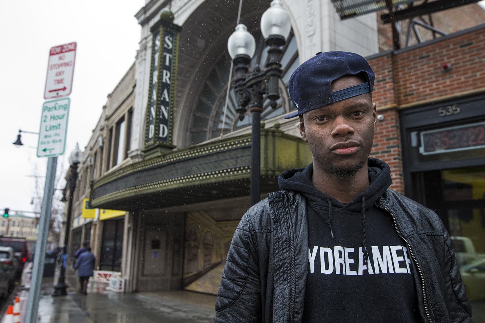 Tory Bullock standing outside the Strand Theatre in Dorchester. (Jesse Costa/WBUR)