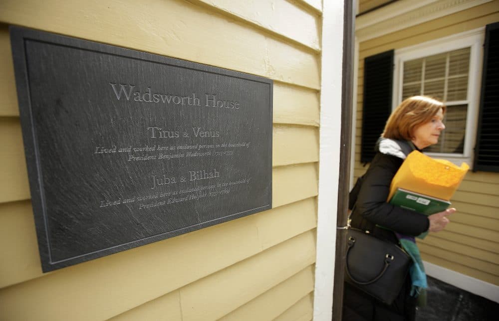 As American universities grapple with their connections to slavery, Harvard University is putting its ties on display. Last year, a plaque commemorating four enslaved people who lived and worked at the school's Wadsworth House was hung outside. And an exhibit on display now features some of the few documents discovered so far that offer records of the enslaved people who lived and worked at the school. (Steven Senne/AP)