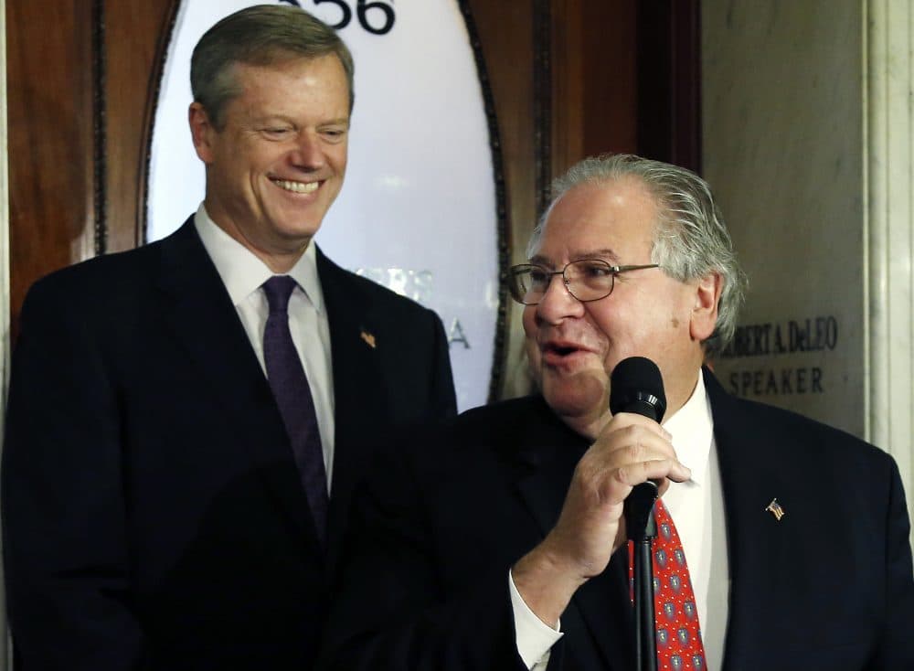 In this 2014 file photo, then-Gov.-elect Charlie Baker smiles as House Speaker Robert DeLeo speaks to reporters. (Elise Amendola/AP)