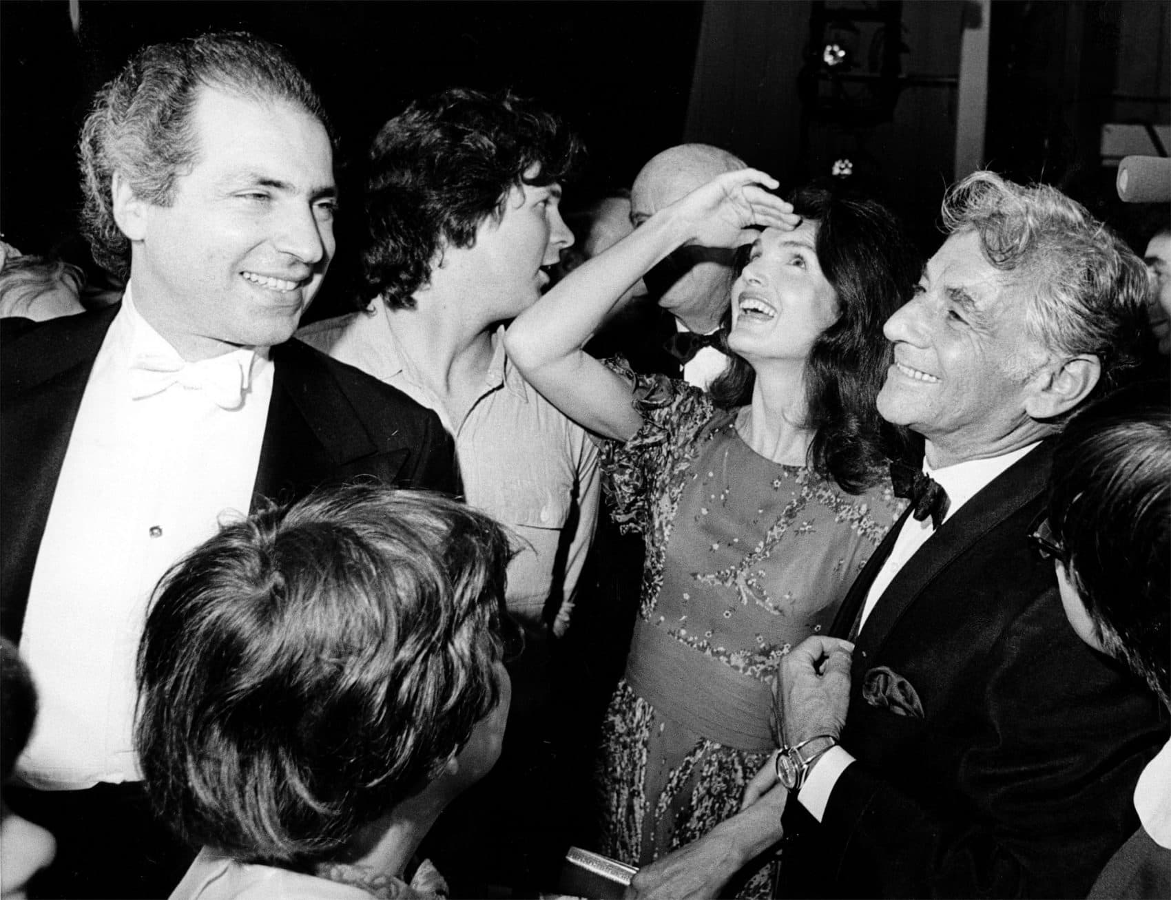 Jacqueline Kennedy Onassis shields the light from her eyes as she looks up at the stage in Washington's John F. Kennedy Center for the Performing Arts on June 5, 1972. With her is conductor-composer Leonard Bernstein, who wrote "Mass" for the opening of the cultural center. (AP)