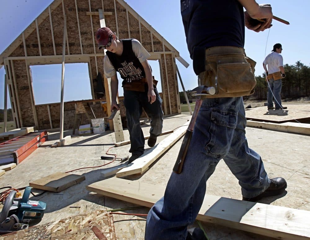 In this 2006 photo, Upper Cape Cod Regional Technical School sophomore David Shaw, left, and senior Mark Dillon, foreground, construct a new press box overlooking the school's baseball field during a carpentry class. (Chitose Suzuki/AP)
