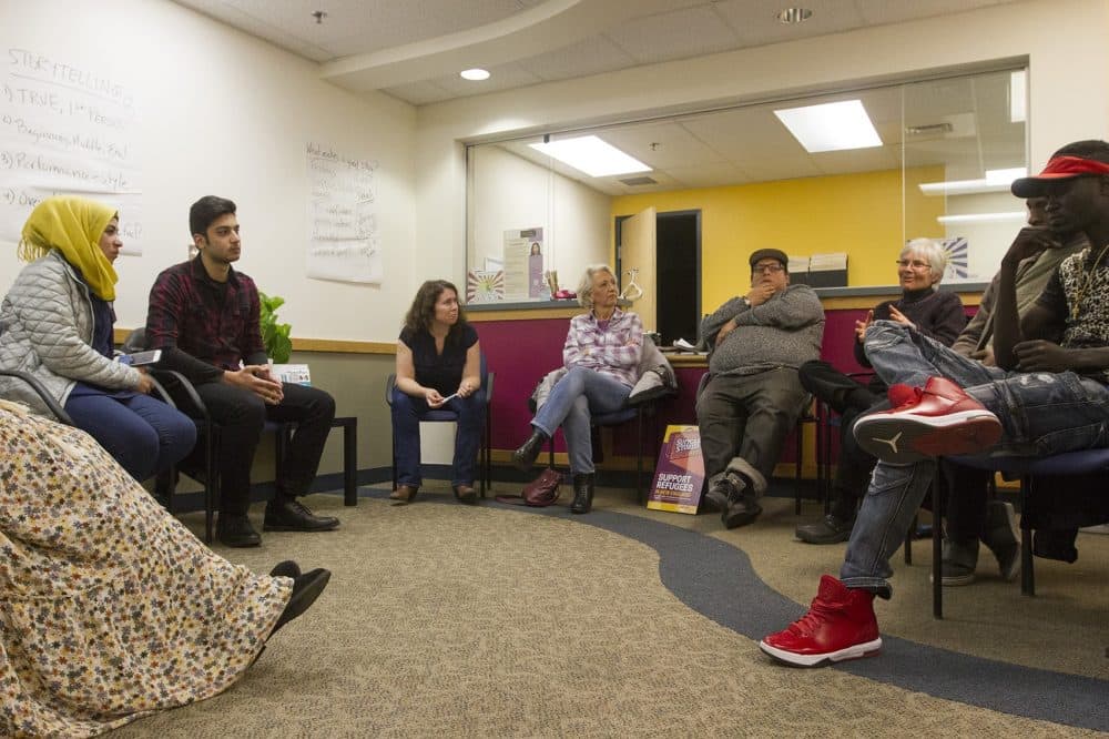 The organizer behind the International Institute of New England and Massmouth's live storytelling collaboration &quot;Suitcase Stories&quot; sees it as a way to break down cultural barriers and turn strangers into neighbors. Here, a group of potential storytellers gather at the International Institute's Lowell office for a storytelling workshop. (Joe Difazio for WBUR)