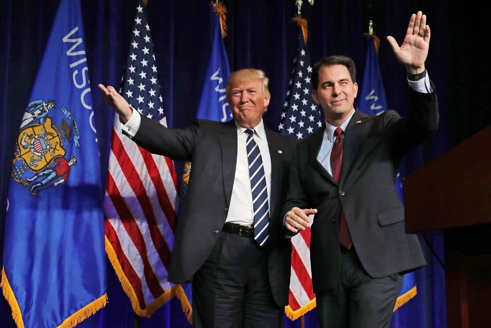 Wisconsin Gov. Scott Walker welcomes then-Republican presidential nominee Donald Trump onstage during a campaign rally in November 2016 in Altoona, Wisc. (Chip Somodevilla/Getty Images)