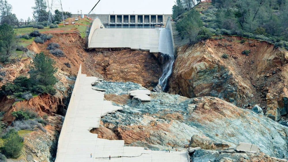 Ruins of the main spillway at Oroville Dam reveal a blend of "fresh" (blue-gray) rock and "weathered" (reddish-brown) rock underneath. (Calif. Dept. of Water Resources)