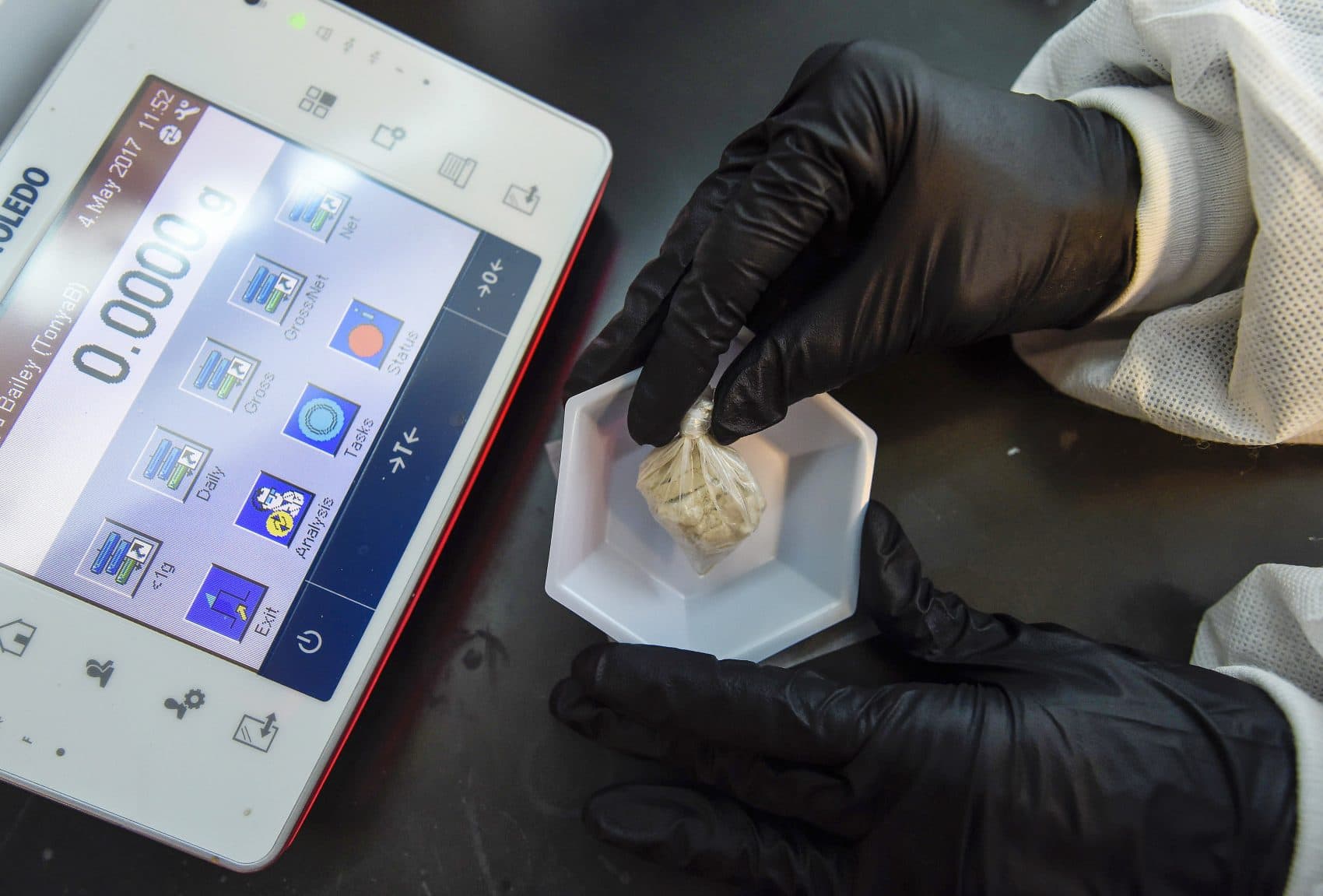A forensic chemist prepares a sample of the drug "gray death" to be weighed at the crime lab of the Georgia Bureau of Investigations in Decatur, Ga., on Thursday, May 4, 2017. The new and dangerous opioid combo underscores the ever-changing nature of the U.S. addictions epidemic. (Mike Stewart/AP)