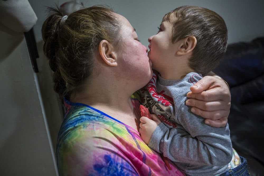 Rosa Benitez, the longtime partner of Jose Flores, and their 2-year-old son Brandon. Flores was arrested and detained by ICE after he sought legal counsel to get workers' compensation for a broken femur. Benitez and Flores have five children together. (Jesse Costa/WBUR)