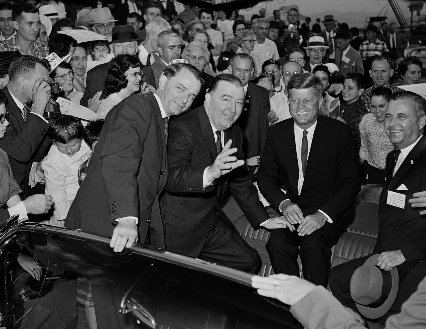 Democratic presidential hopeful Sen. John F. Kennedy, second right, is welcomed by West Virginia Senators Robert C. Byrd and Jennings Randolph, from left, and State Attorney General and Democratic nominee for governor, W.W. Barron, extreme right, as he arrives for a speaking appearance at Civic Hall in Charleston, W. Va., September 19, 1960. (AP Photo)