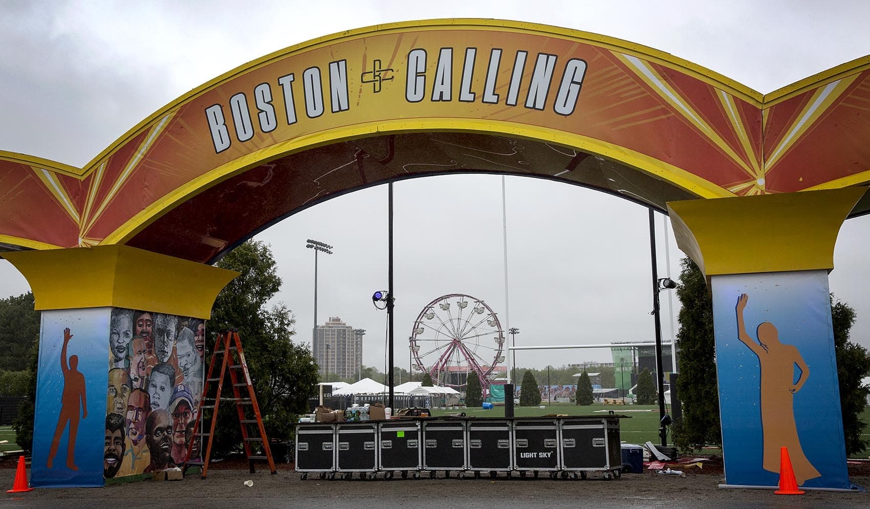 Construction of the entrance to Boston Calling is almost complete on a wet Thursday afternoon. The ferris wheel awaits the arrival of the crowds on Friday. (Robin Lubbock/WBUR)