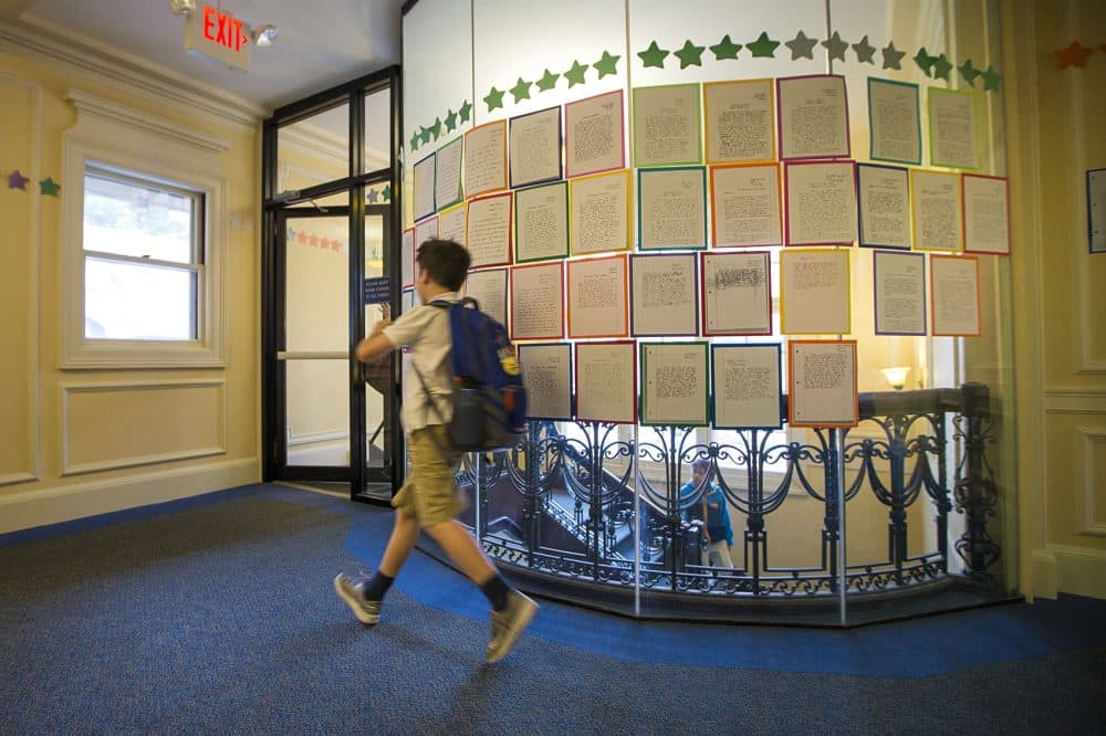 A student walks by essays at the Landmark School in Manchester-By-The-Sea. (Jesse Costa/WBUR)