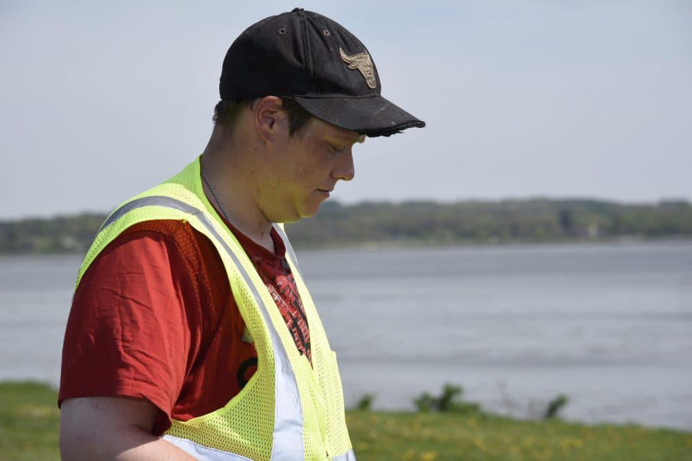 Peter LaRoche picks up trash around the Back Cove in Portland. (Ed Morin/Maine Public)