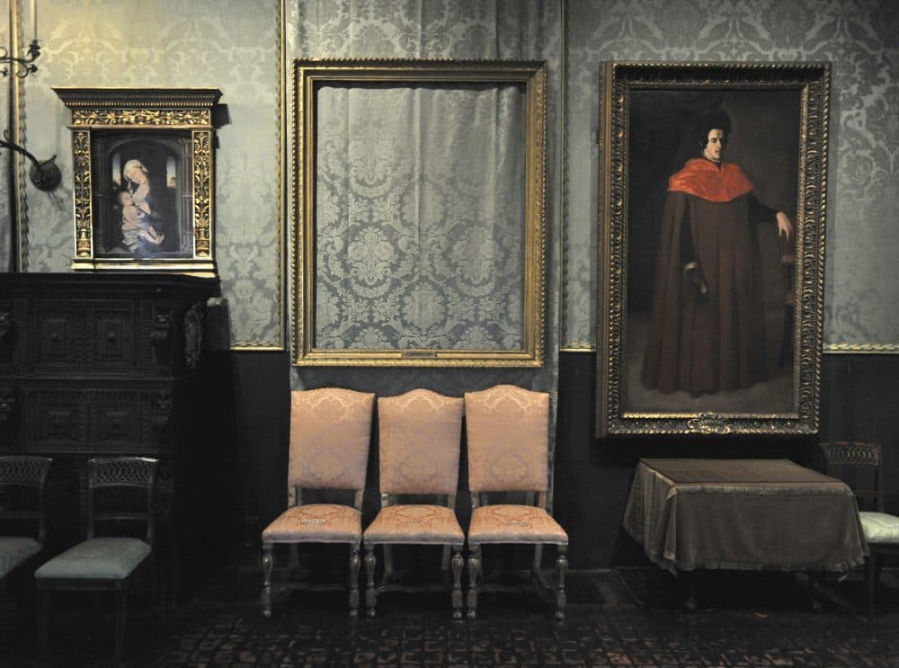 In this Thursday, March 11, 2010 photo, the empty frame, center, from which thieves cut Rembrandt's "Storm on the Sea of Galilee" remains on display at the Isabella Stewart Gardner Museum in Boston. (Josh Reynolds/AP)