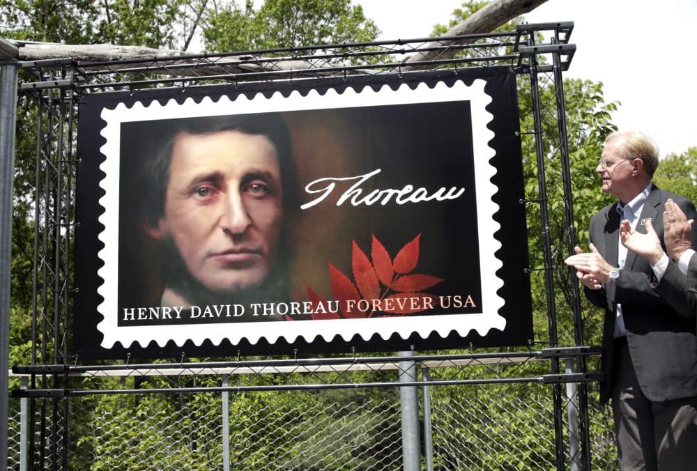 Actor and environmentalist Ed Begley Jr., a board member of the Walden Woods Project, applauds during the dedication of the U.S. Postal Service's new Henry David Thoreau postage stamp Tuesday at Walden Pond, where the 19th century American philosopher and naturalist spent two years in solitude and reflection. (Elise Amendola/AP)