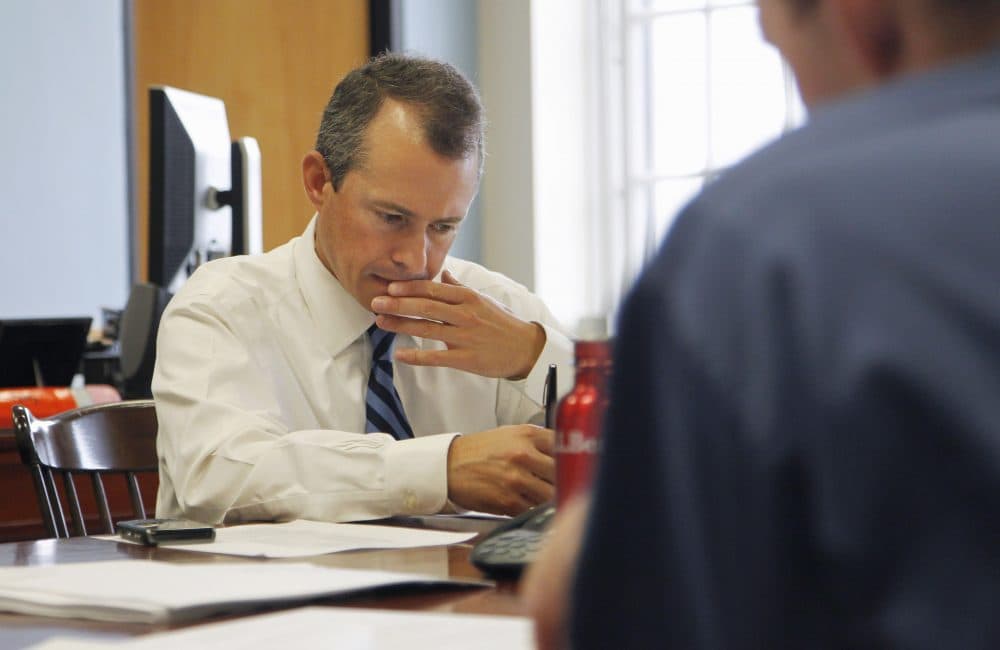 In 2011, then-state Secretary of Finance Jay Gonzalez, left, meets with his budget team at the State House. Gonzalez is now mounting a campaign for governor. (Steven Senne/AP)