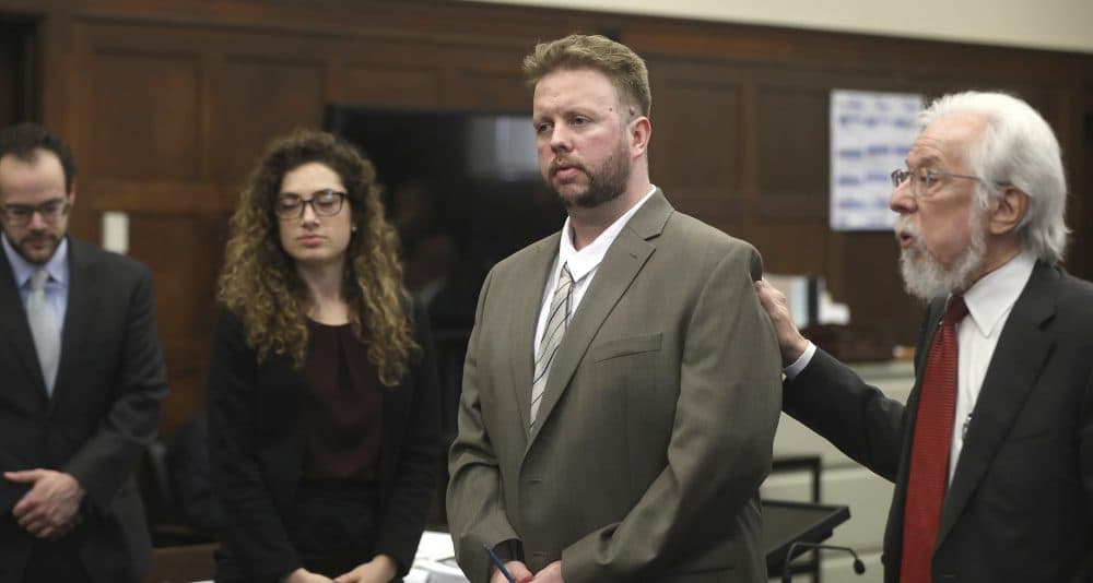 Defense attorney Jonathan Shapiro, right, introduces Michael McCarthy, second right, to potential jurors during jury selection in the case. (Pat Greenhouse/The Boston Globe via AP, pool)