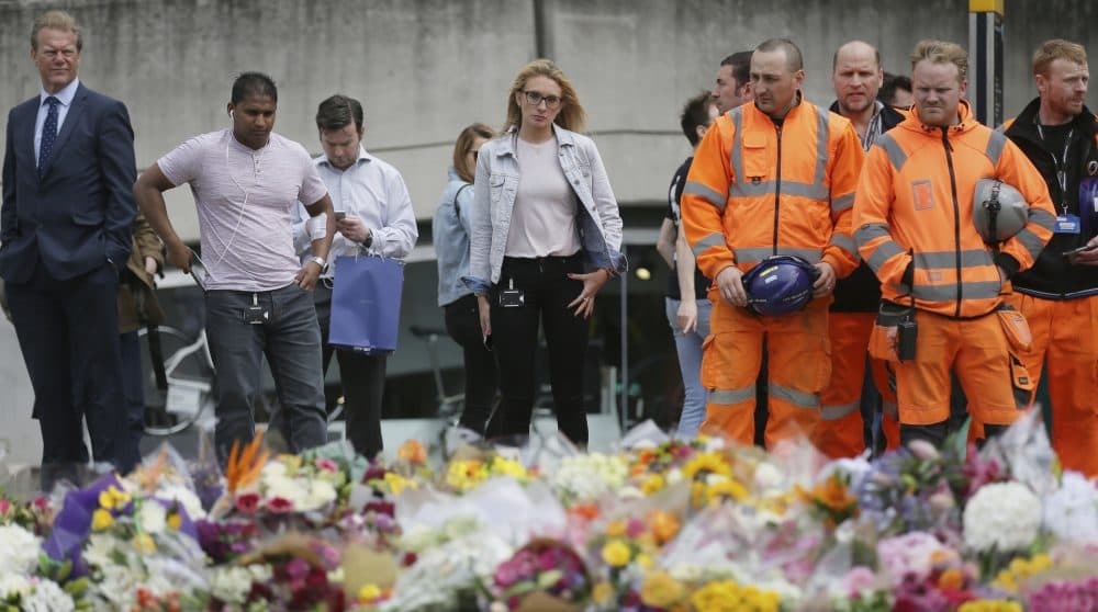 The fear of another attack is something that has become embedded in our collective consciousness, writes Justin Sinclair, whether we realize it or not. Pictured: City workers and others stand after laying flower tributes in London for victims of the terrorist attack on London Bridge, on Monday, June 5, 2017. (Tim Ireland/AP)